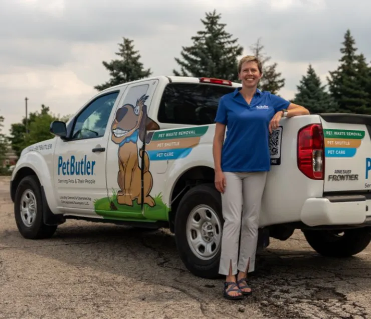 Kelly Amundson, owner of Pet Butler of Rochester, MN, standing next to a Pet Butler truck.