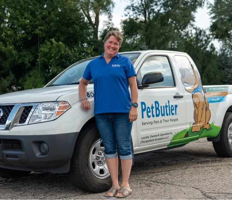 Aimee Braatz, owner of Pet Butler of Waukesha, WI, standing next to a Pet Butler truck.