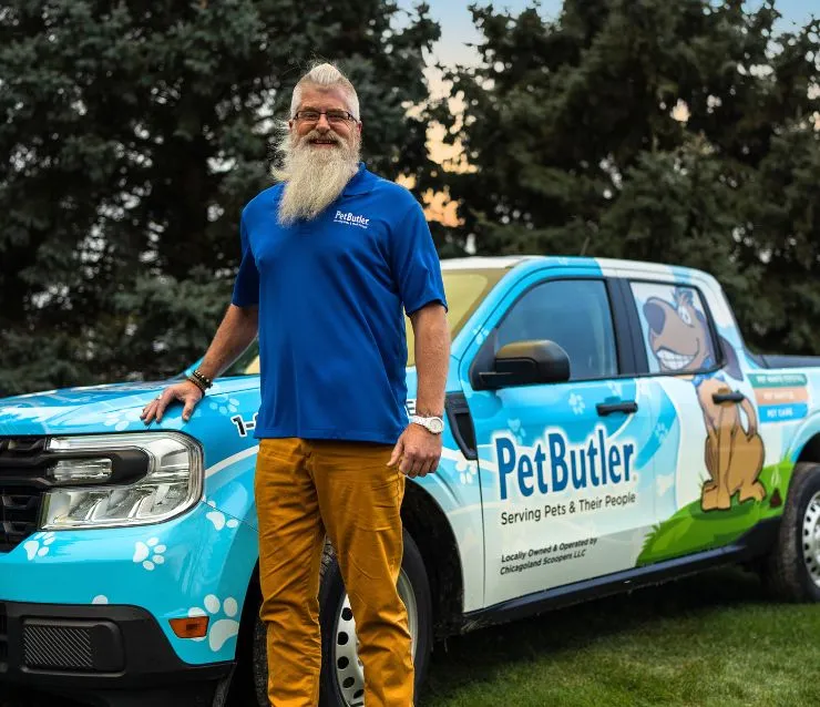 Bryan Pierce, Operations Manager of Pet Butler of Columbus, OH, standing next to a Pet Butler truck.