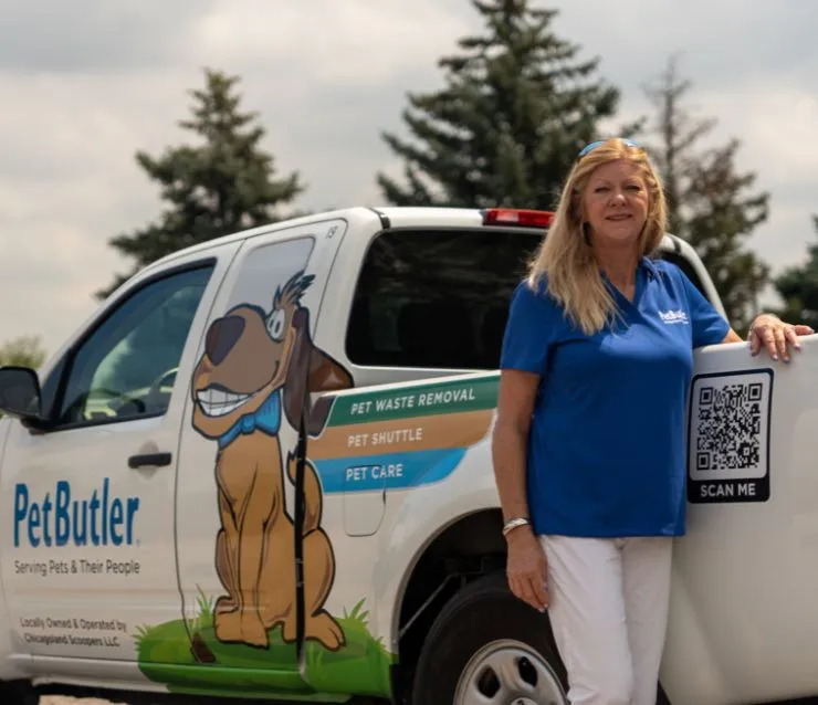 Susan Curtis, owner of Pet Butler of Franklin, TN, standing next to a Pet Butler truck.