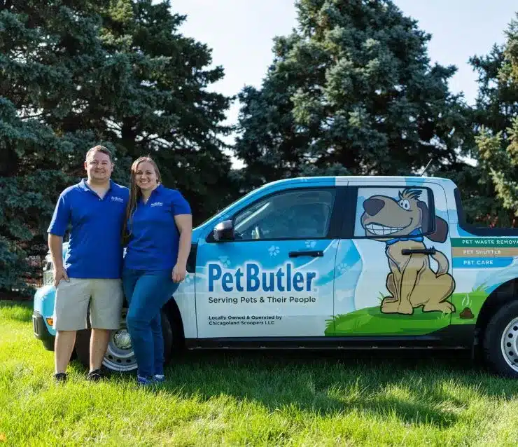 Nick and Rachel Graziano, owners of Pet Butler of Ann Arbor, MI, standing next to a Pet Butler truck.