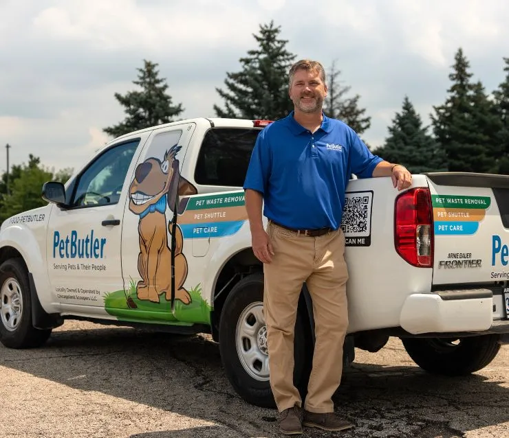 Pat Lanigan, owner of Pet Butler of Des Moines, IA, standing next to a Pet Butler truck.