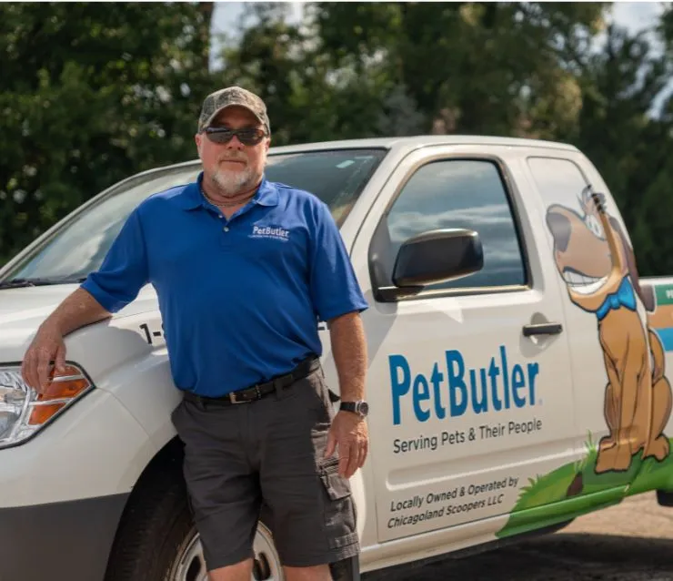 Rusty Lenox, owner of Pet Butler of St. Petersburg, FL, standing next to a Pet Butler truck.
