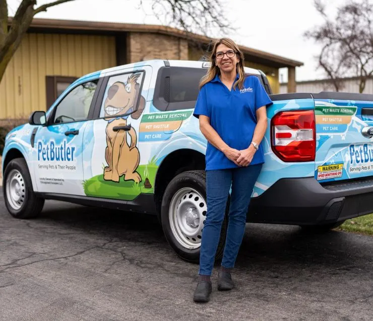 Tami Porteous, owner of Pet Butler of Grand Rapids, MI, standing next to a Pet Butler truck.