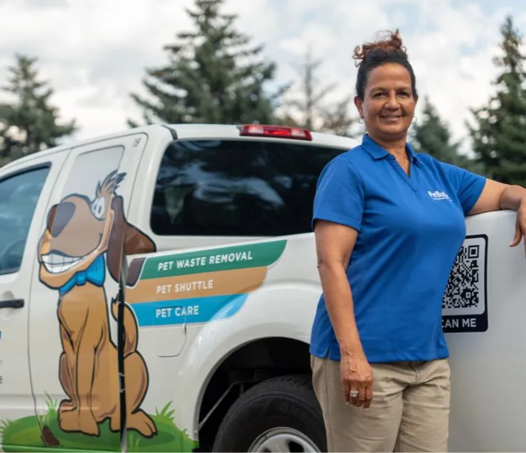 Rebecca Stewart, owner of Pet Butler of Lithonia, GA, standing next to a Pet Butler truck.