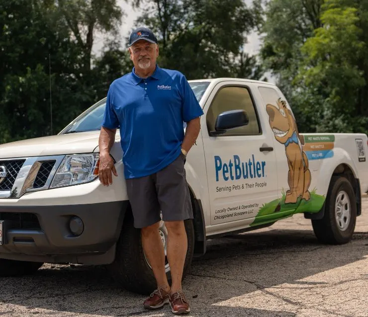 Don Stone, owner of Pet Butler of Dallas, TX, standing next to a Pet Butler truck.