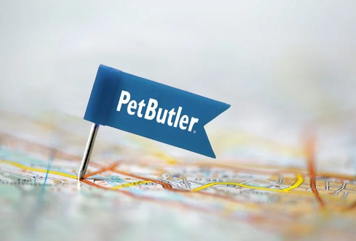 Small, blue Pet Butler logoed flag pinned to a map.